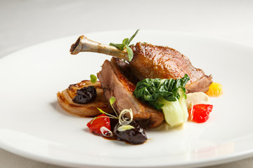 Well-browned and crisp duck confit with roast fennel, citrus fruit  prune sauce. Roasted  leg. White dish