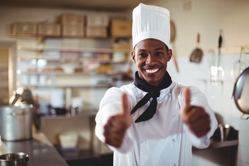 Portrait of smiling chef showing thumbs up - obrazy, fototapety, plakaty