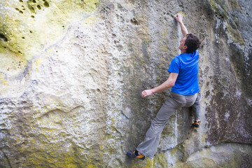 A rock climber climbs up the mountain.