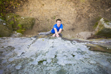 Climber is bouldering on the rocks.