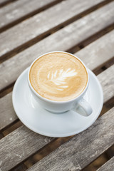 cappuccino cup on wood background