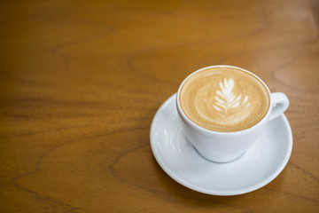 cappuccino cup on wood background