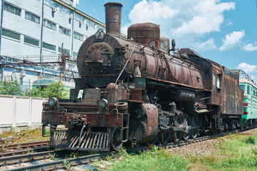 Fototapeta na wymiar Old, rusty, vintage steam locomotive on rails