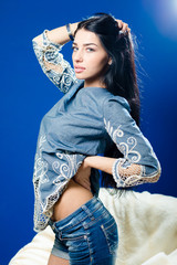 portrait of beautiful young lady posing on blue light copy space background