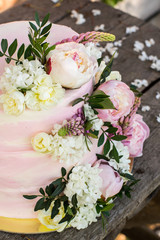 Big pink wedding cake decorated by natural flowers