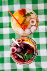 fresh Cocktail juice with mint and ice on table. Healthy organic drinks. Fresh mojito drink with ice and fruit