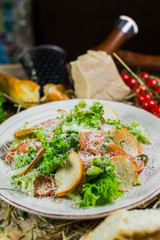 Beautiful fresh salad with lettuce, tomatoes, croutons and Parmesan cheese