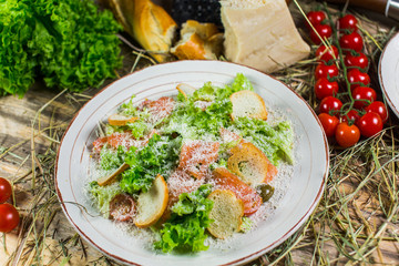 Beautiful fresh salad with lettuce, tomatoes, croutons and Parmesan cheese