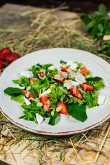 Beautiful fresh sweet salad with strawberries and mint leaves
