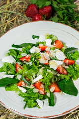 Beautiful fresh sweet salad with strawberries and mint leaves