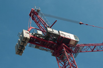 Heavy industrial tower crane on blue sky