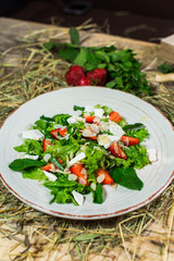 Beautiful fresh sweet salad with strawberries and mint leaves