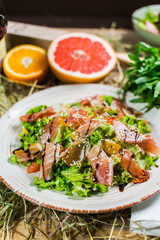 Beautiful fresh salad with lettuce, tomatoes, ham and Parmesan