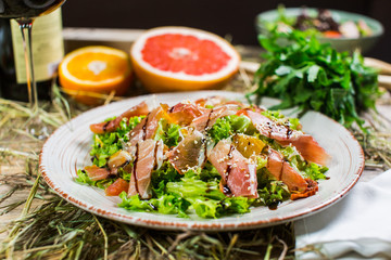 Beautiful fresh salad with lettuce, tomatoes, ham and Parmesan