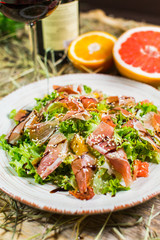Beautiful fresh salad with lettuce, tomatoes, ham and Parmesan