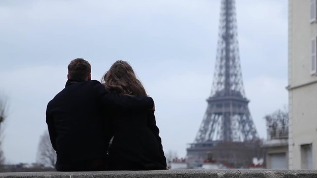 Happy couple having a good time in Paris at the Eiffel Tower