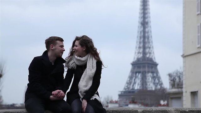 Happy couple having a good time in Paris at the Eiffel Tower