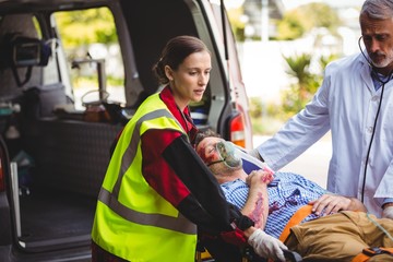 Ambulance crew and doctor taking care of an injured person