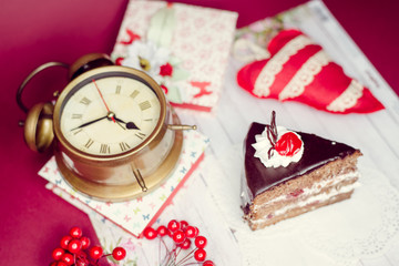Image close up on set of alarm clock, gift boxes and cake