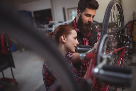 Mechanics repairing a bicycle