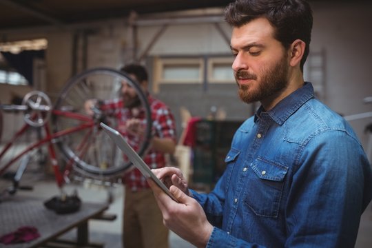 Side view of man mechanic using a tablet computer