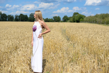 Full side length of beautiful young lady in white dress, wheat field