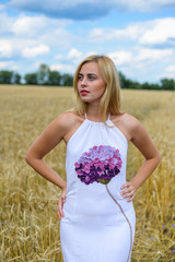 Fototapeta na wymiar Beautiful young lady in white dress, wheat field background