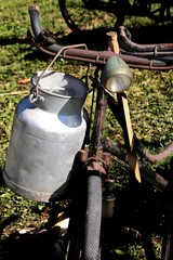old Milk Canister and rusty historic bike milkman
