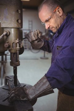 Tradesman working with machine