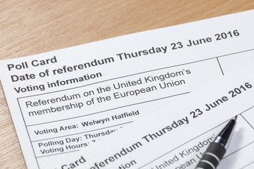 Poll cards for the UK's EU referendum laying on a table