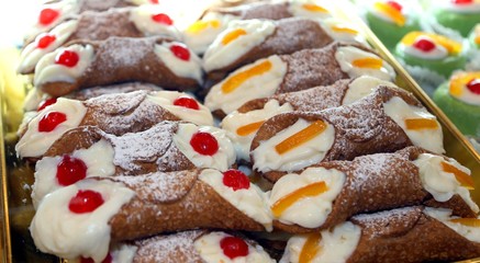 Sicilian cannoli with custard and cherries or candied fruit