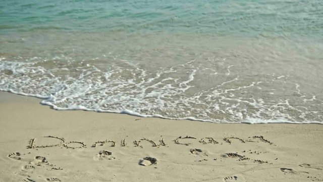 Dominicana Drawn In The Sea Sand. Rinse With Sea Water