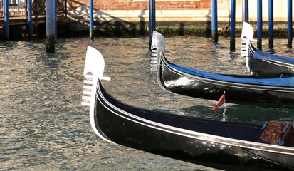 Fototapeta na wymiar Venetian gondolas sail the Adriatic Sea near Saint Mark's square