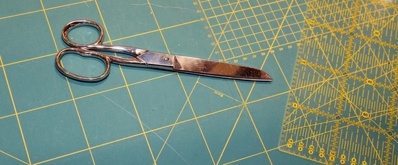 tailor's scissors on the worktop with millimeter scale backgroun