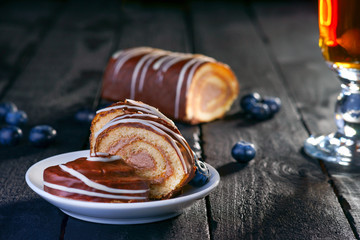 Slices of Swiss roll, blueberry and tea