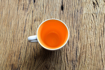 Fototapeta na wymiar Empty coffee or tea cup on grunge wooden background