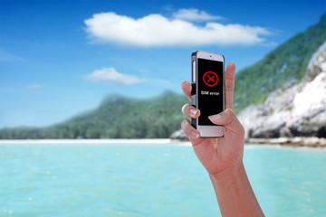 "SIM Error" showing on the smartphone with tropical island background.