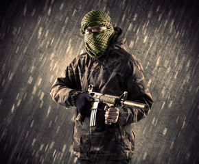 Armed terrorist man with mask on rainy background