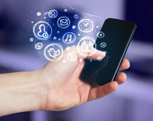 Hand holding smartphone with mobile app choices