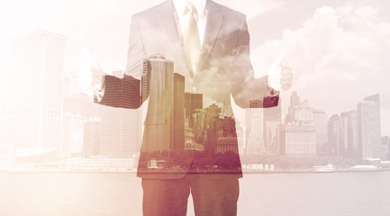 Businessman standing at cityscape background