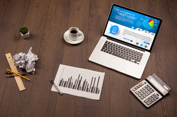 Laptop on office desk with business website on screen