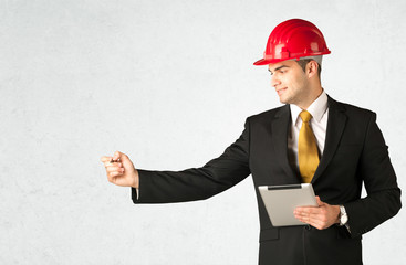 Young architect drawing in empty space