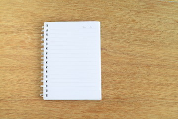 White notebook on wooden background