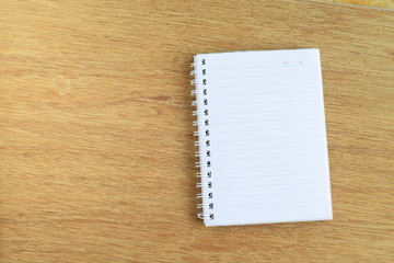 White notebook on wooden background