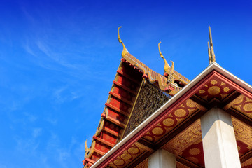 Fototapeta na wymiar Thai temple ceramic roof on blue skies background.