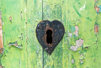 Old grungy green door and rusted lock
