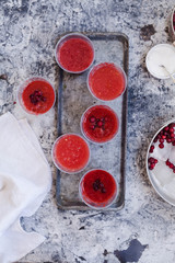 Red curant, cranberry ice smoothie or drink with fruit.