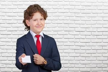 smiling boy holding blank paper