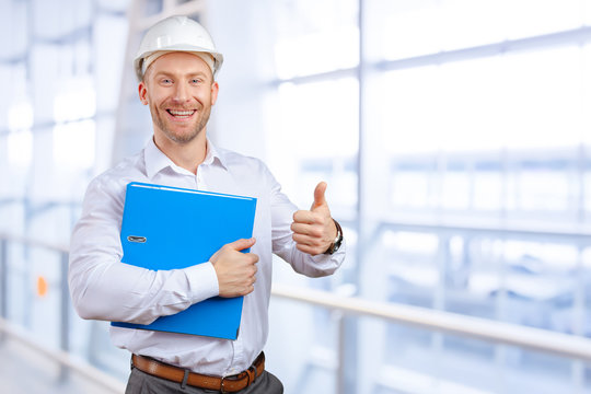 Happy young businessman architect smiling