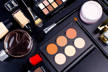 Cosmetics on dark background, closeup